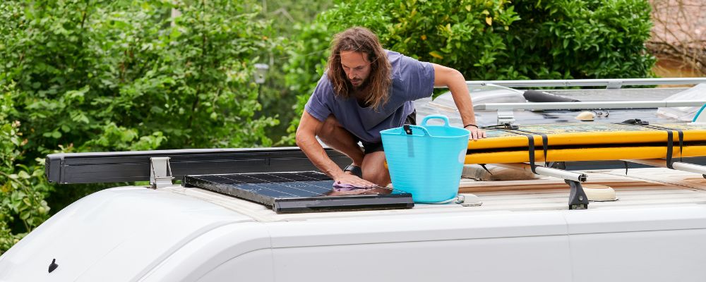 man cleaning caravan